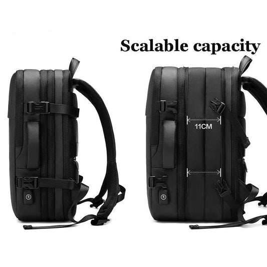 Computer Backpack in black Oxford material with expandable capacity, zipper closures, side handle, and adjustable straps.