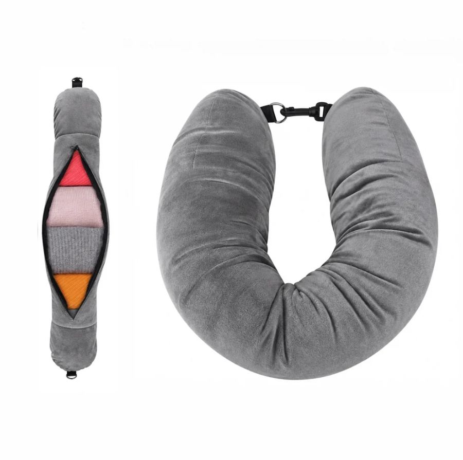 Airplane pillow in soft grey fabric with a U shape and a zippered pocket for storage, featuring a clip closure.