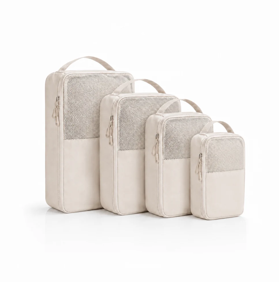 Organizer-Set of four beige fabric travel pouches with mesh panels and top handles, varying sizes for versatile storage.