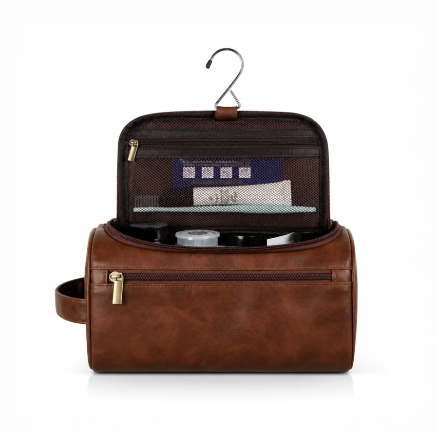 Travel toiletry bag in brown faux leather with multiple compartments, a hook, and a zippered mesh pocket for organization.